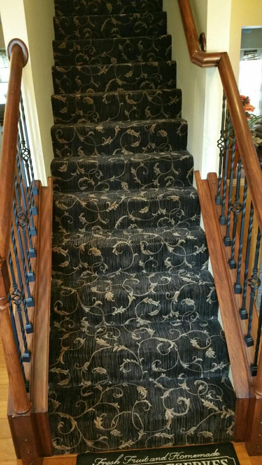 Black and gold damask carpet on stairs